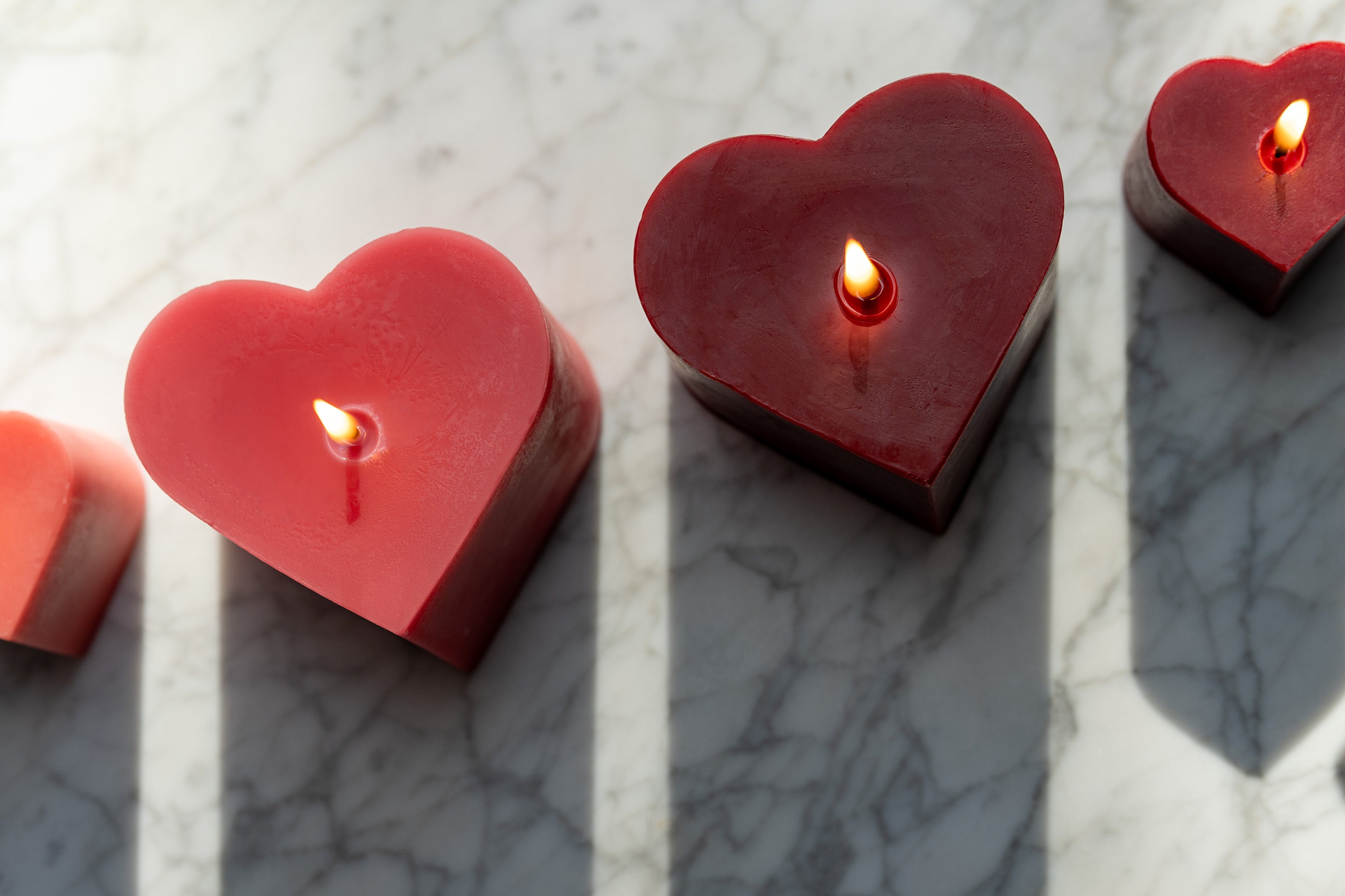 Sunbeam Candles assorted beeswax heart candles lit on a table