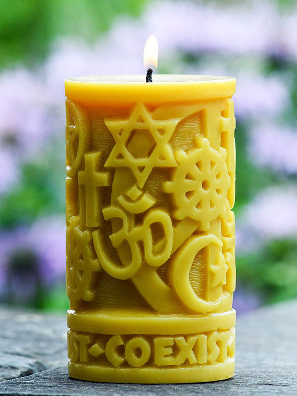 Coexist in Peace pillar lit outside