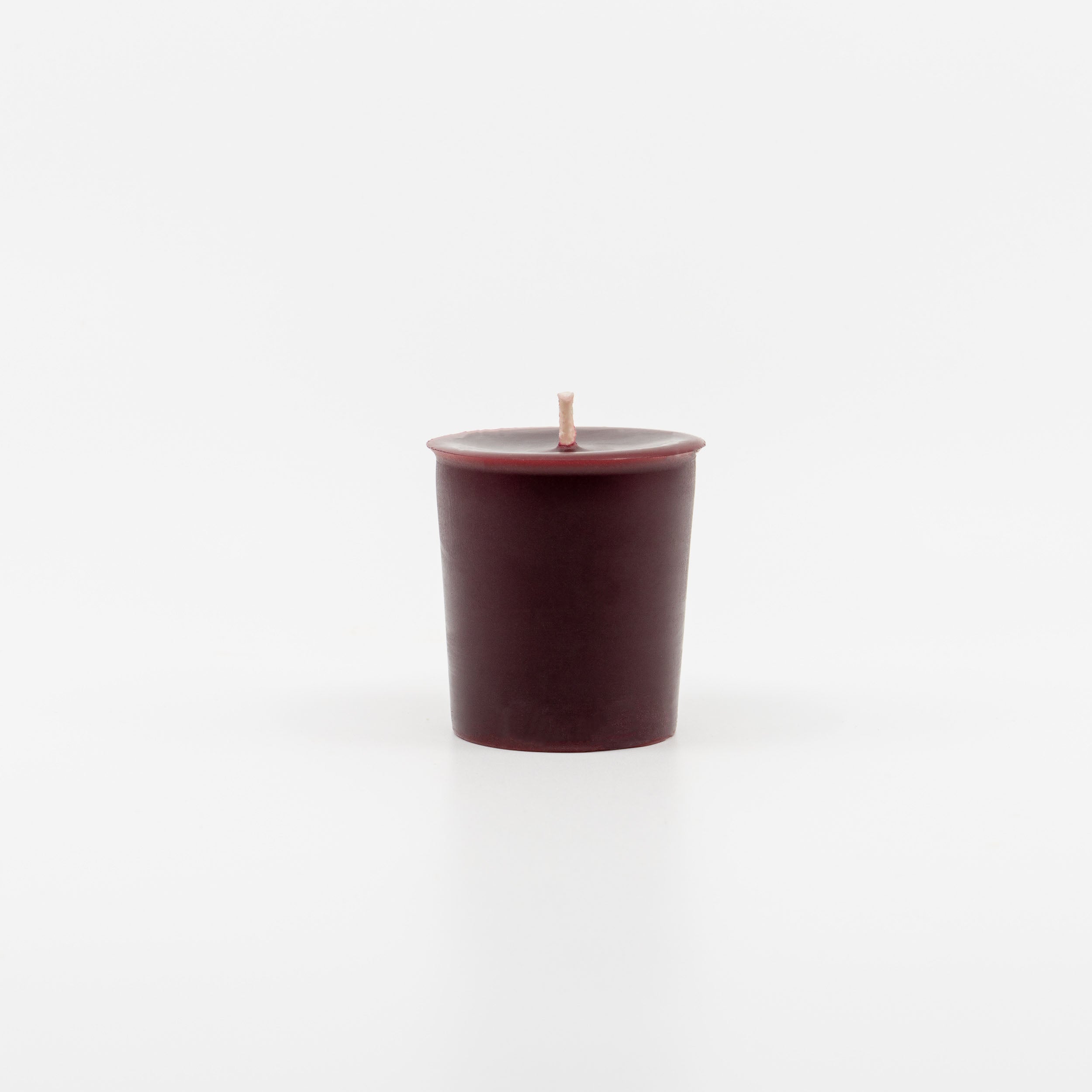 Sunbeam Candles pure burgundy Beeswax Frankincense Bergamot & Orange Votive candle on a white background