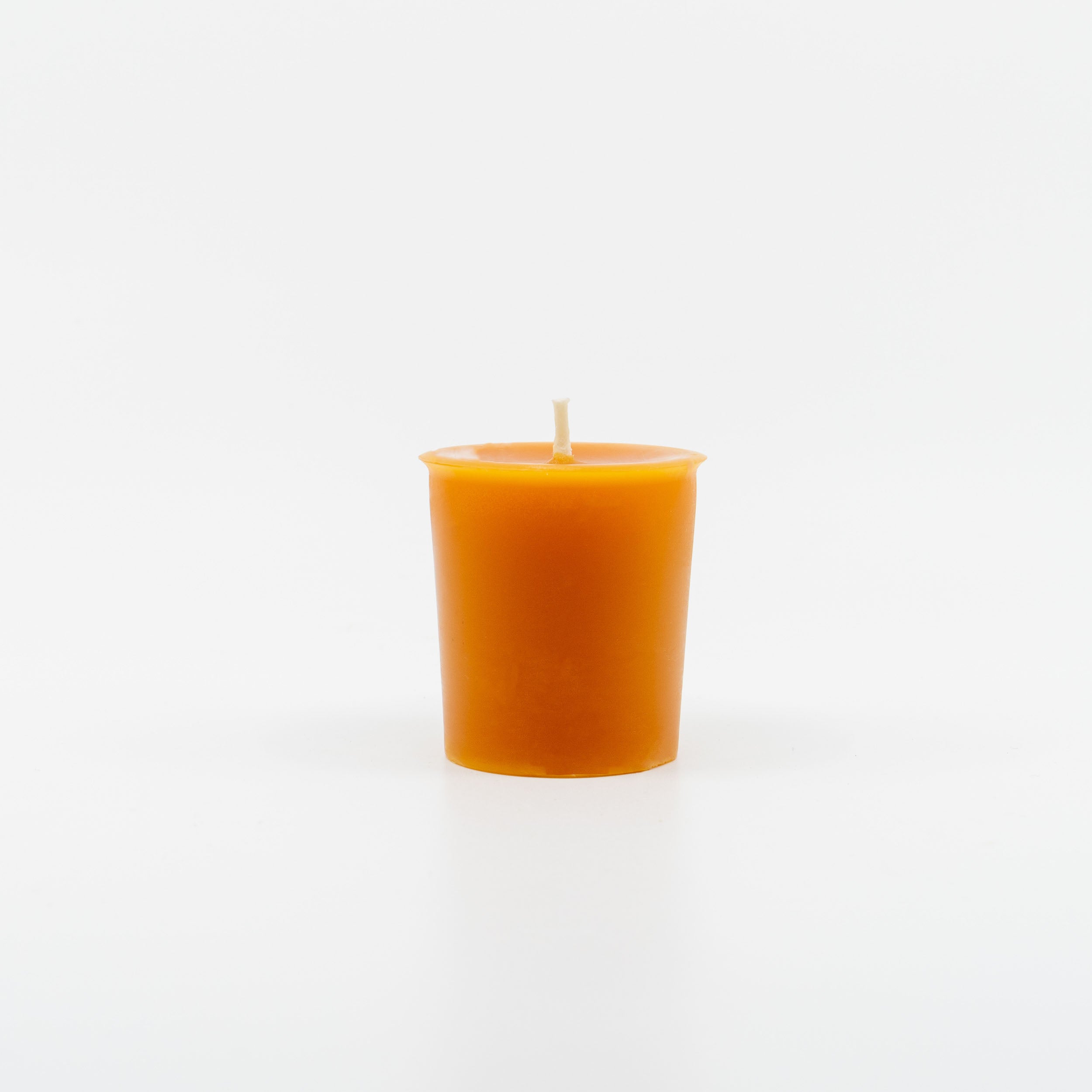 Sunbeam Candles Pure Beeswax saffron Lemongrass, Sage & Ginger votive candle with white background