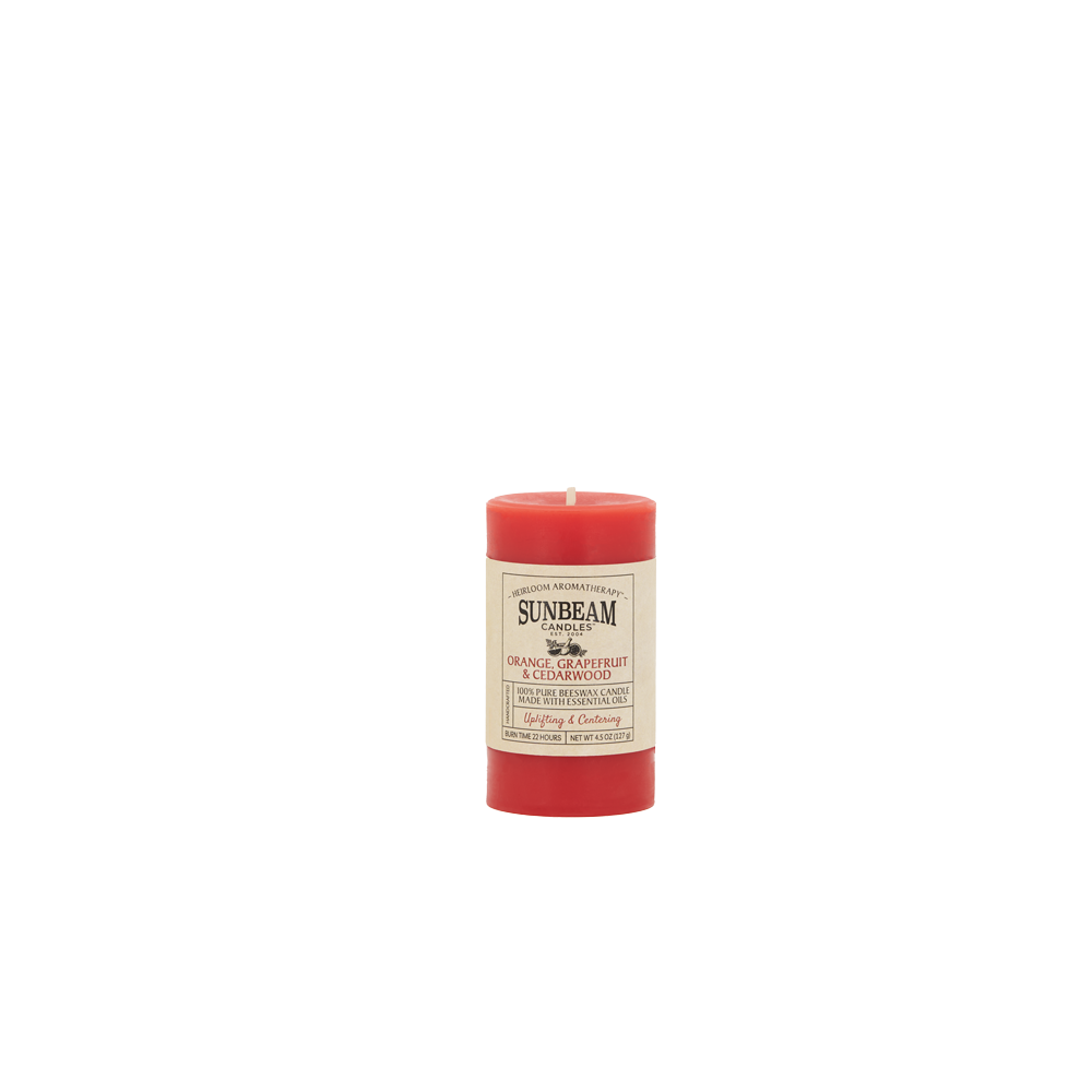 Sunbeam Candles Pure Beeswax reddish-orange Orange, Grapefruit & Cedarwood 2"x3.25" pillar candle with white background