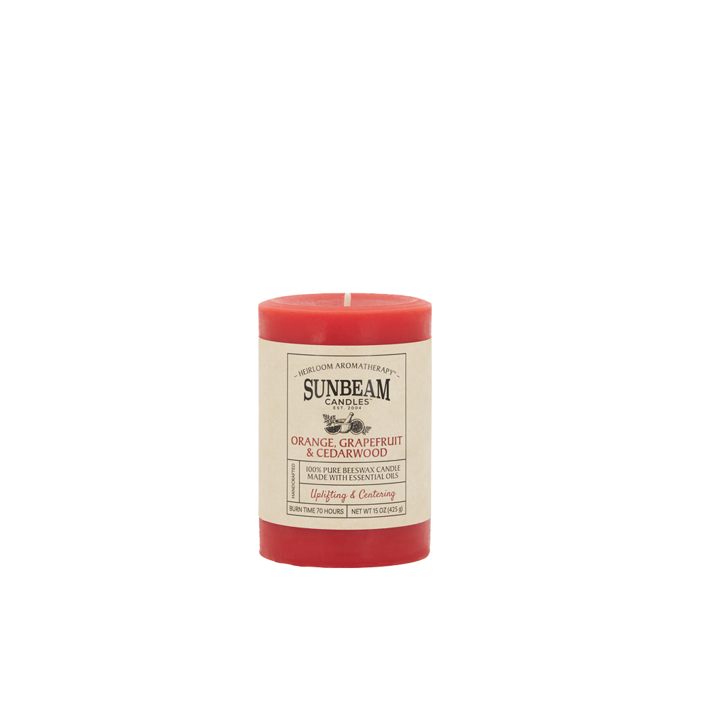 Sunbeam Candles Pure Beeswax reddish-orange Orange, Grapefruit & Cedarwood 3"x 4.25" pillar with white background