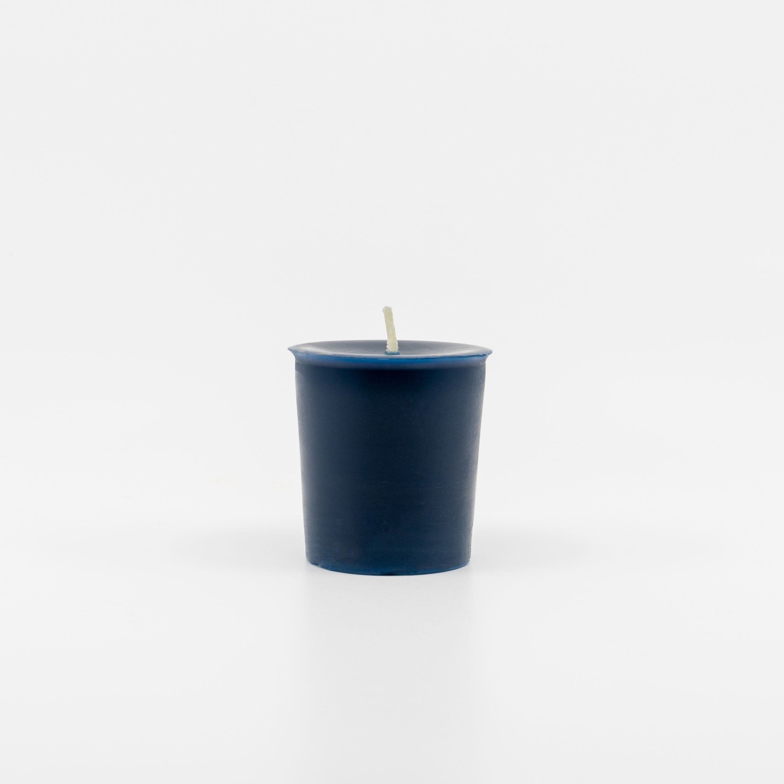 Single blue Sunbeam Candles Pure Beeswax blue Peppermint, Lavender & Bergamot votive candle with a white background.