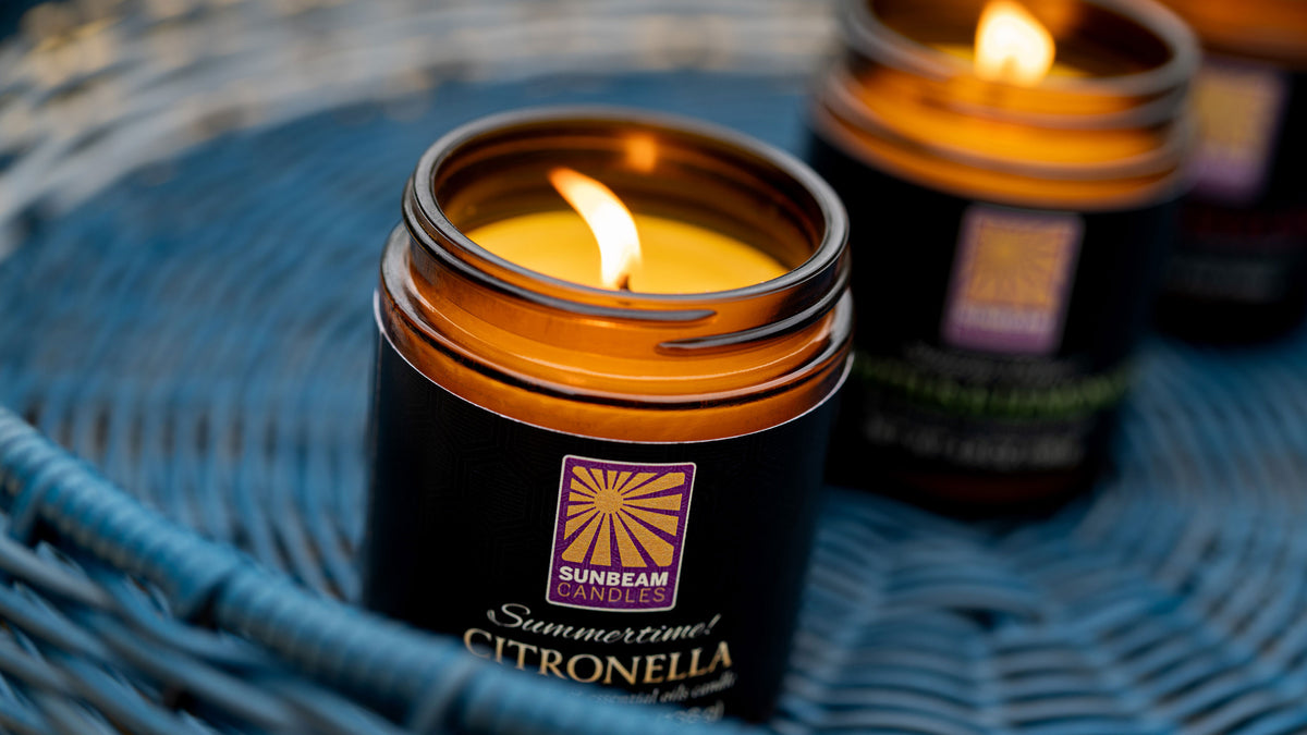 Citronella candle outside in an amber jar