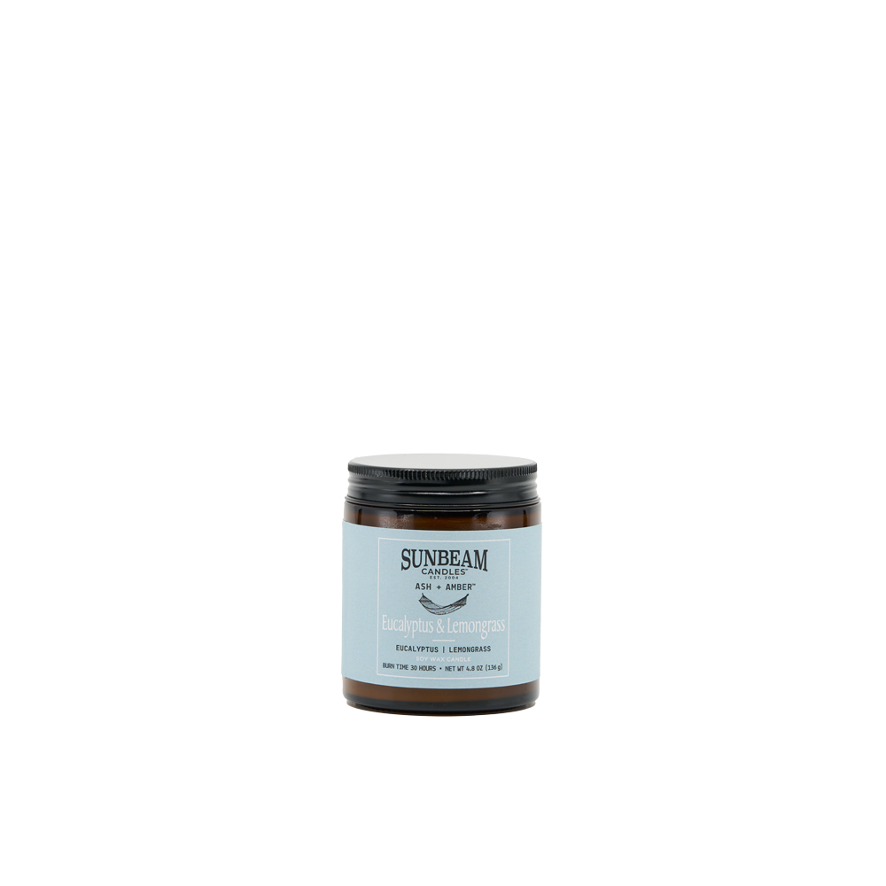 Sunbeam Candles Ash + Amber Summer Scent Eucalyptus & Lemongrass soy wax jar candle with a white background