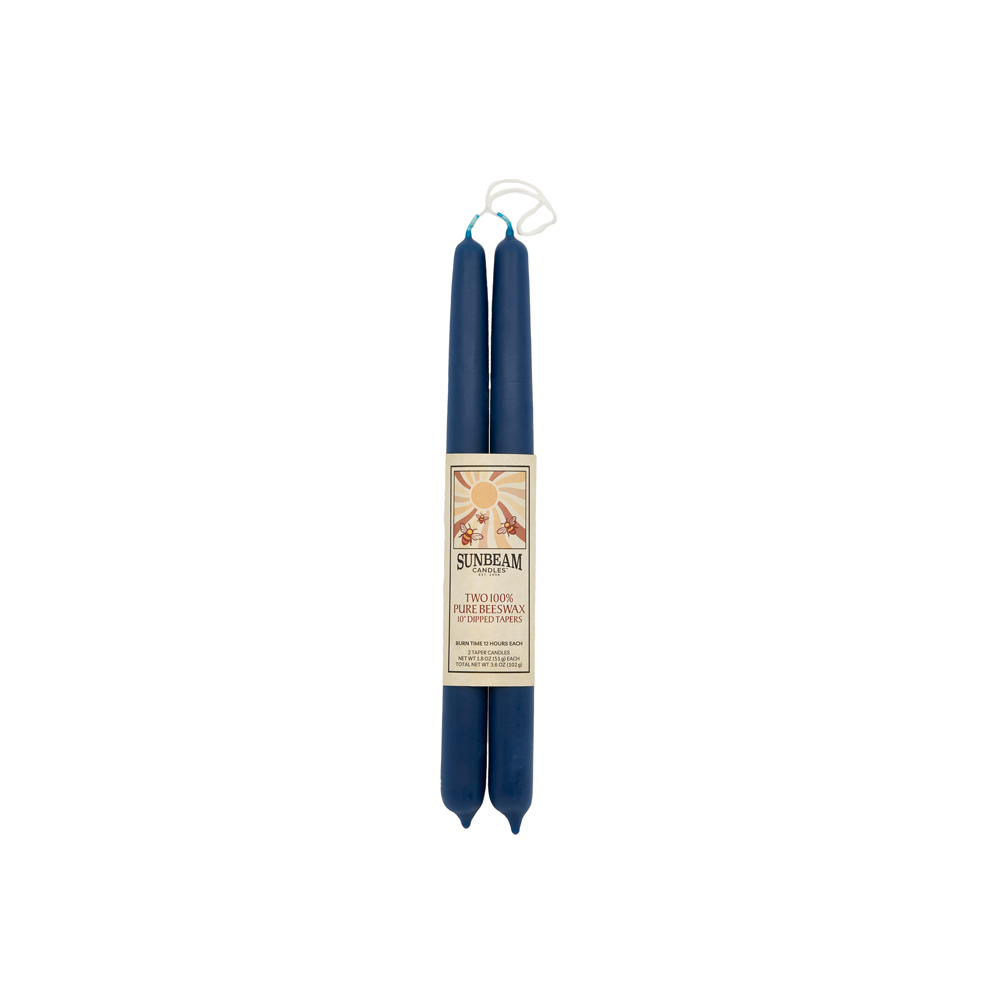 One pair of Sunbeam Candles 10" Beeswax Dipped Indigo Tapers wrapped in a label on a white background