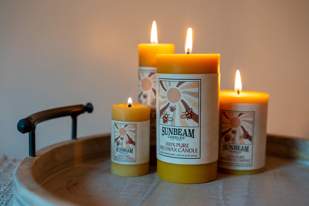 Sunbeam candles on a wooden tray with a neutral background