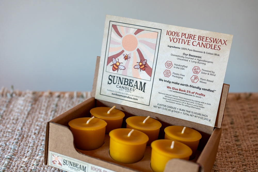 Box of Sunbeam candles with a visible label on a textured surface
