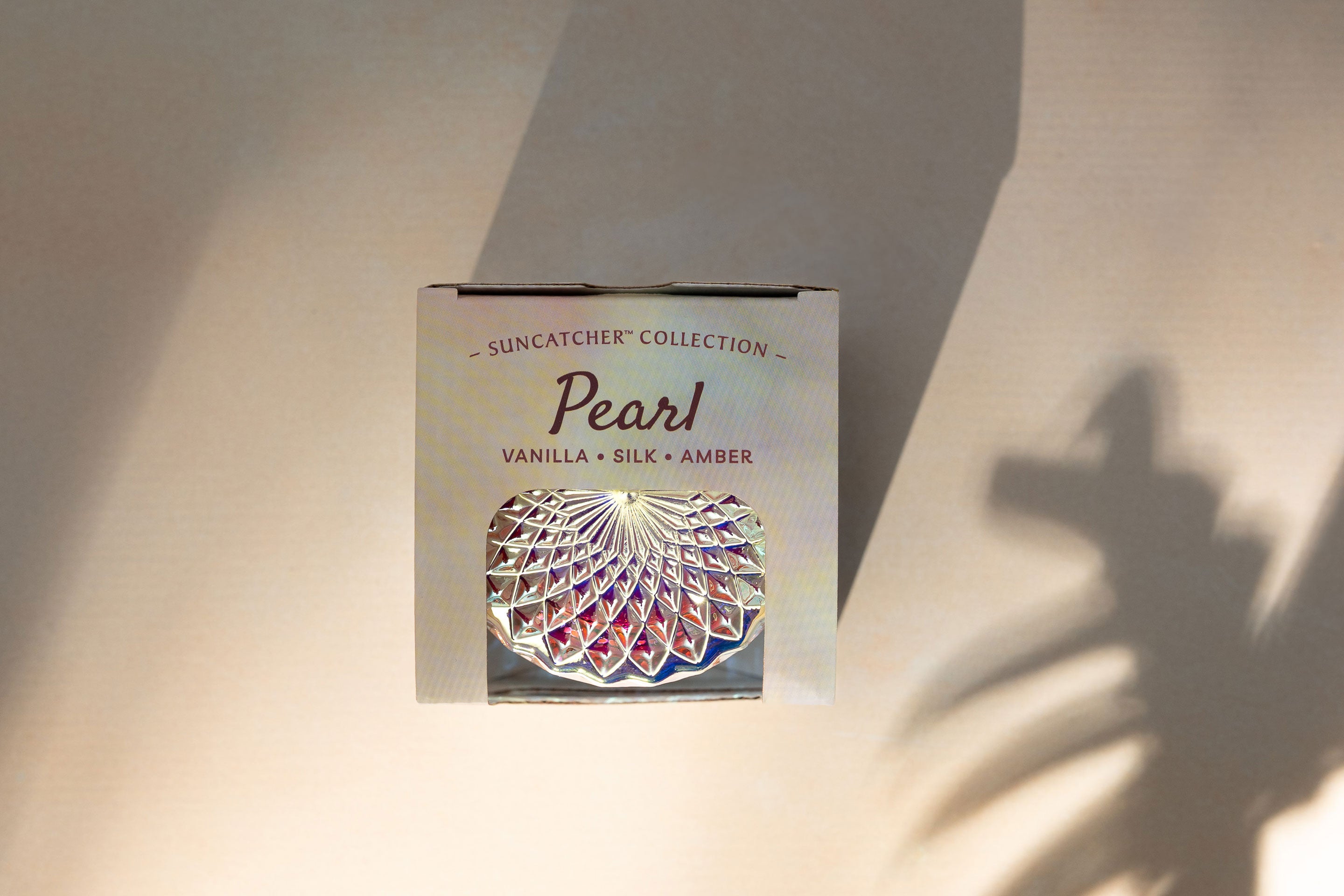 Sunbeam Candles SunCatcher Pearl scent apricot, coconut & soy wax iridescent container candle in box on surface with shadows