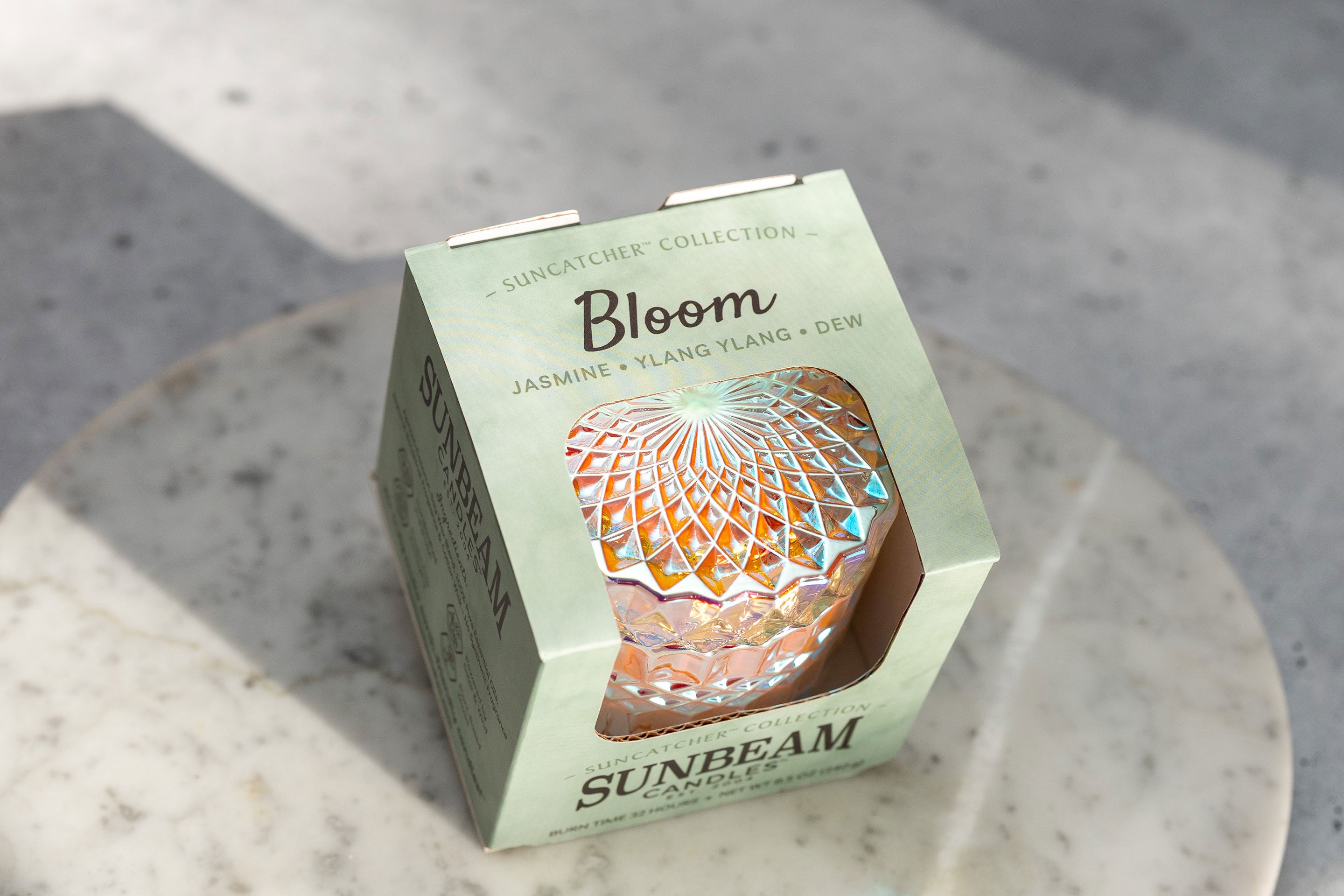 Sunbeam Candles SunCatcher Bloom scent apricot, coconut & soy wax container candle in box on marble tray and table with shadows