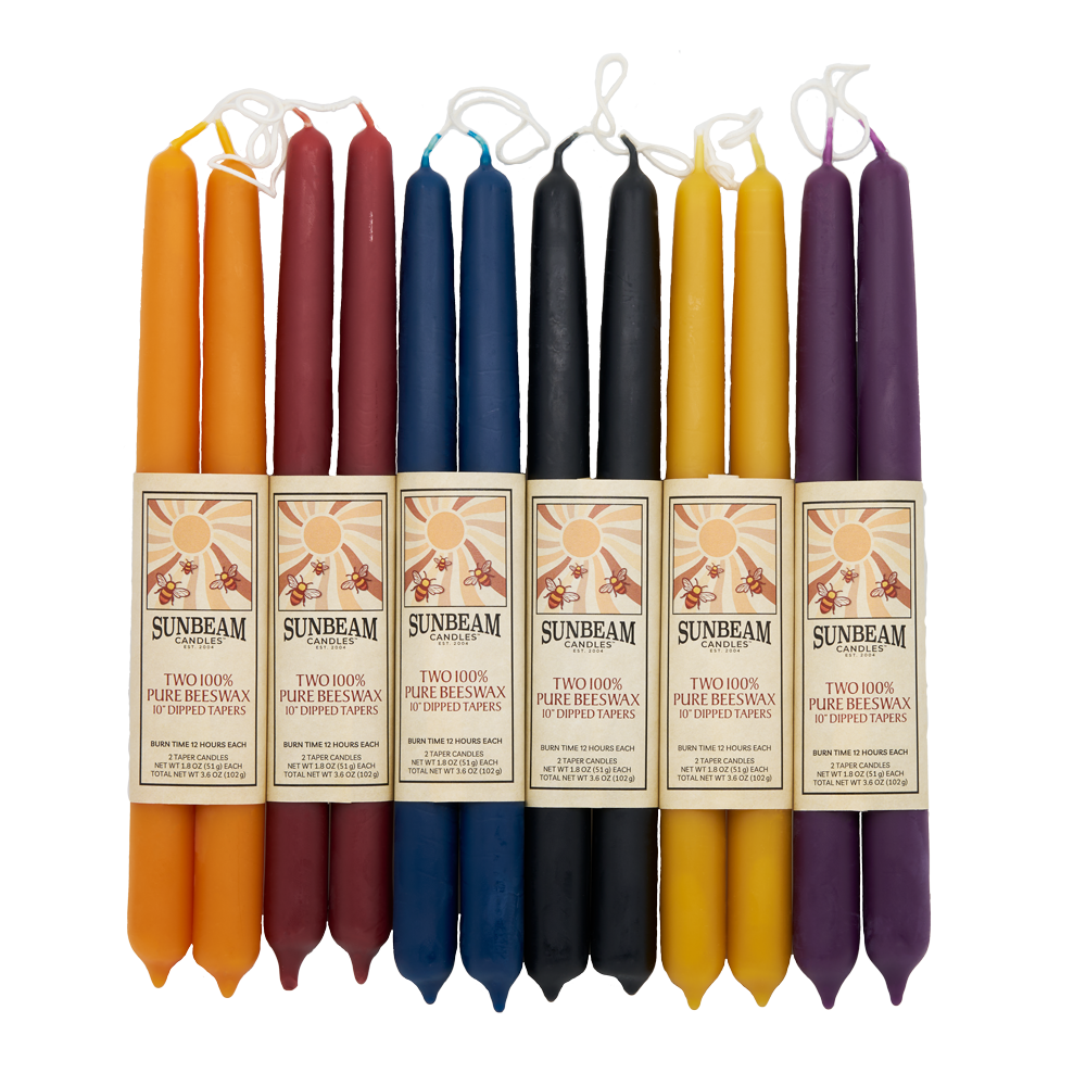 Sunbeam Candles 10" dipped beeswax wrapped tapers in various colors on a white background- Apicot, Crimson, Indigo, Midnight Black, Natural Gold & Plum