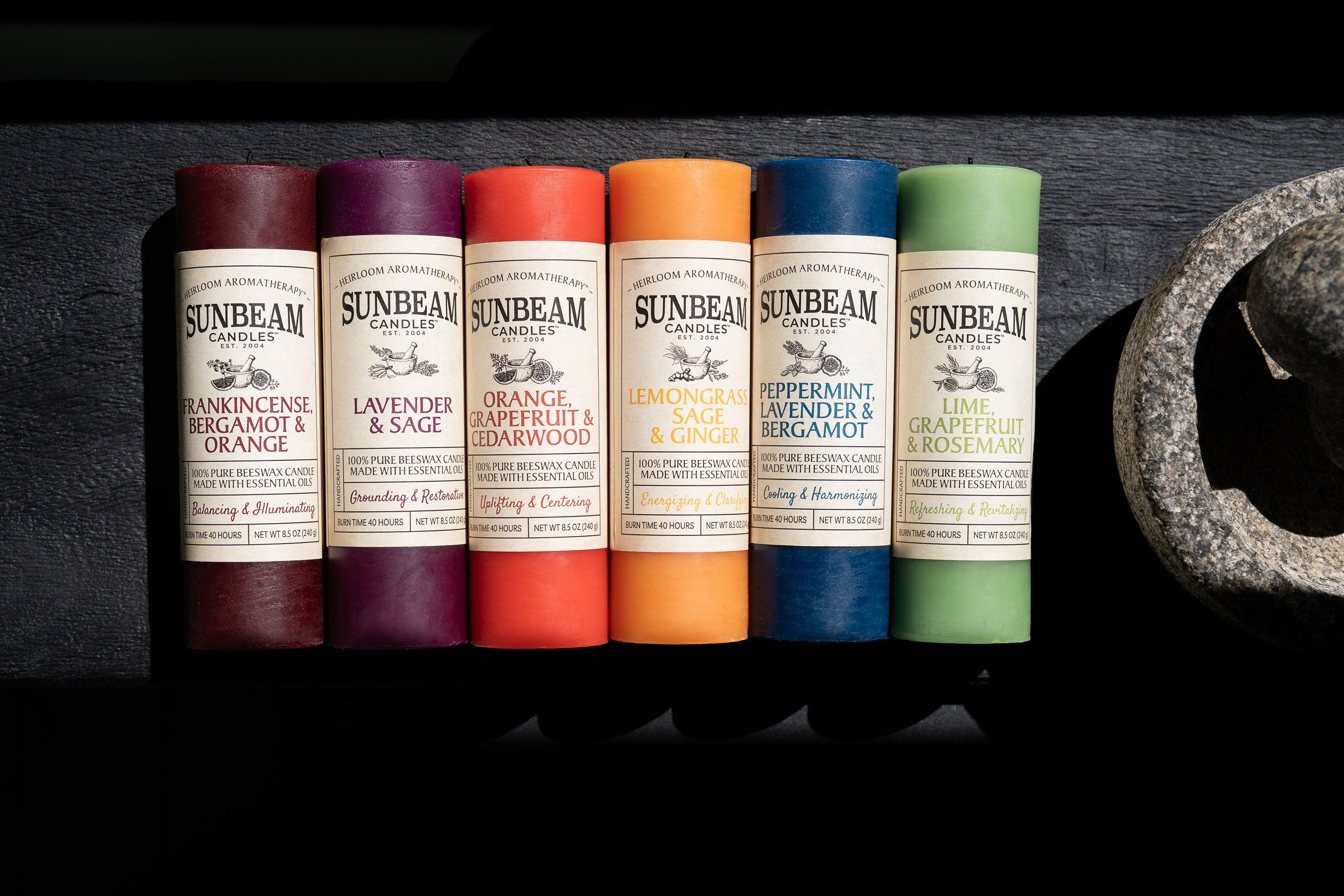Sunbeam candles in various scents on a dark background